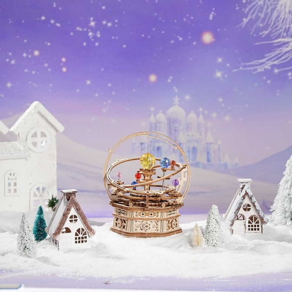 Wooden mechanical model in a snowy landscape with a fantasy castle in the background