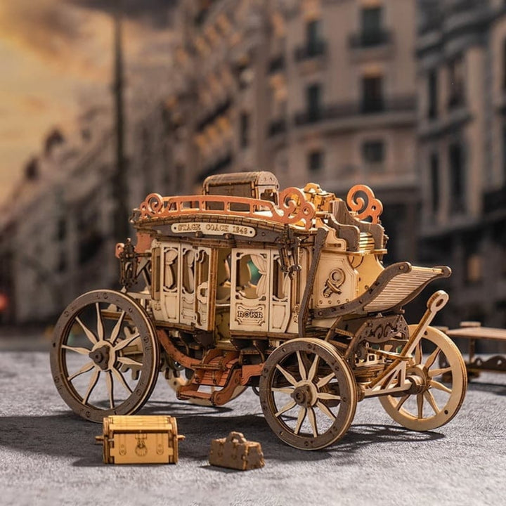 Wooden model of a vintage carriage with detailed design on a blurred street background
