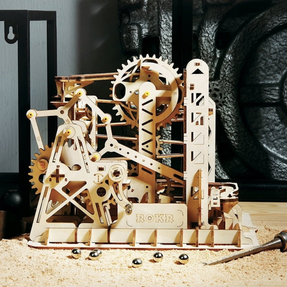 Mechanical model kit with gears and ROKR branding on a wooden surface.