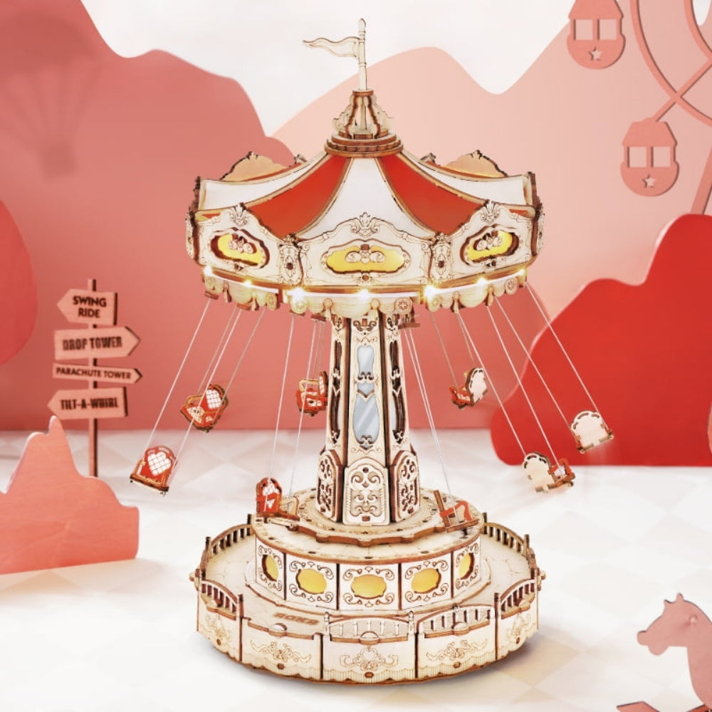 Decorative carousel model with a pink mountain background