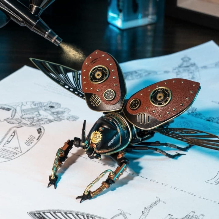 Steampunk-style beetle figurine on technical drawings