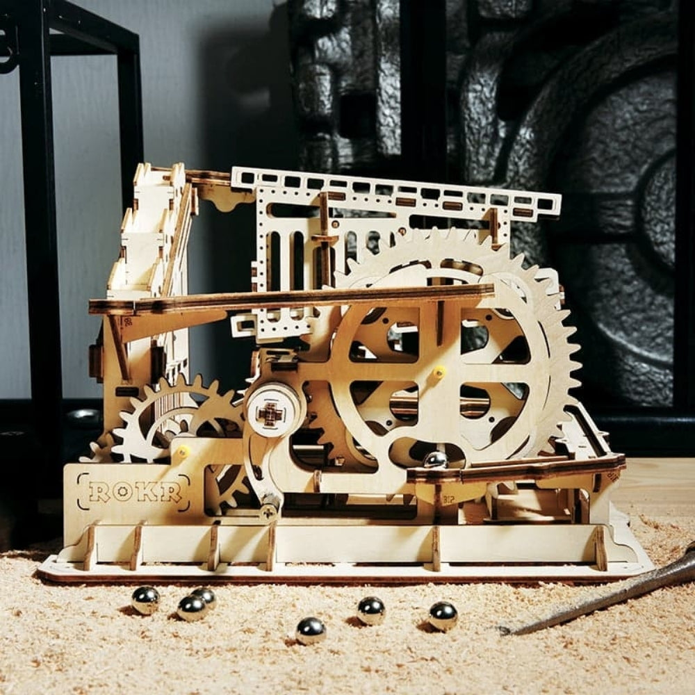 Wooden mechanical model with gears on a wooden surface