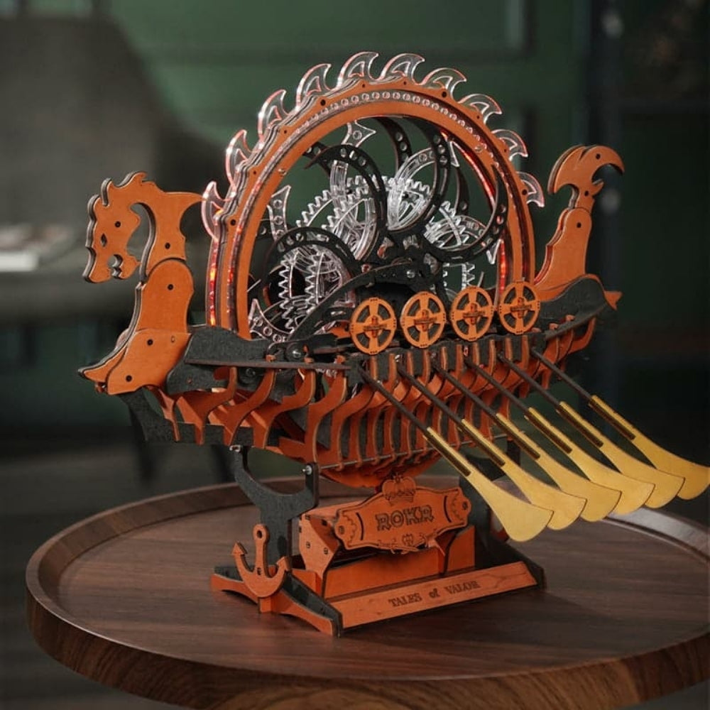 Wooden model of a Viking longship with gears on a wooden stand.