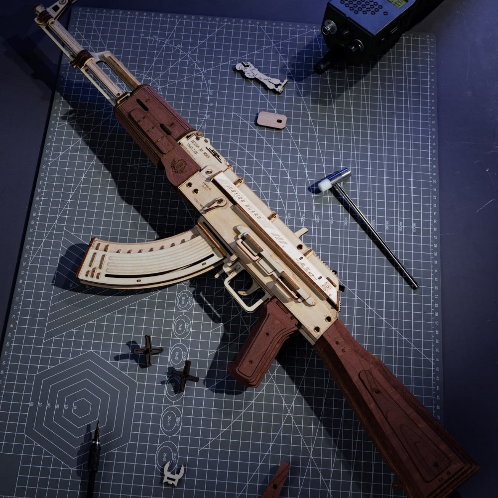 Wooden model of a rifle on a cutting mat with tools