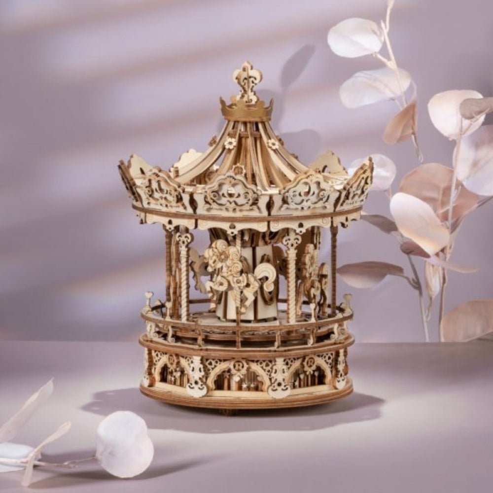 Wooden carousel model on a neutral background with decorative elements