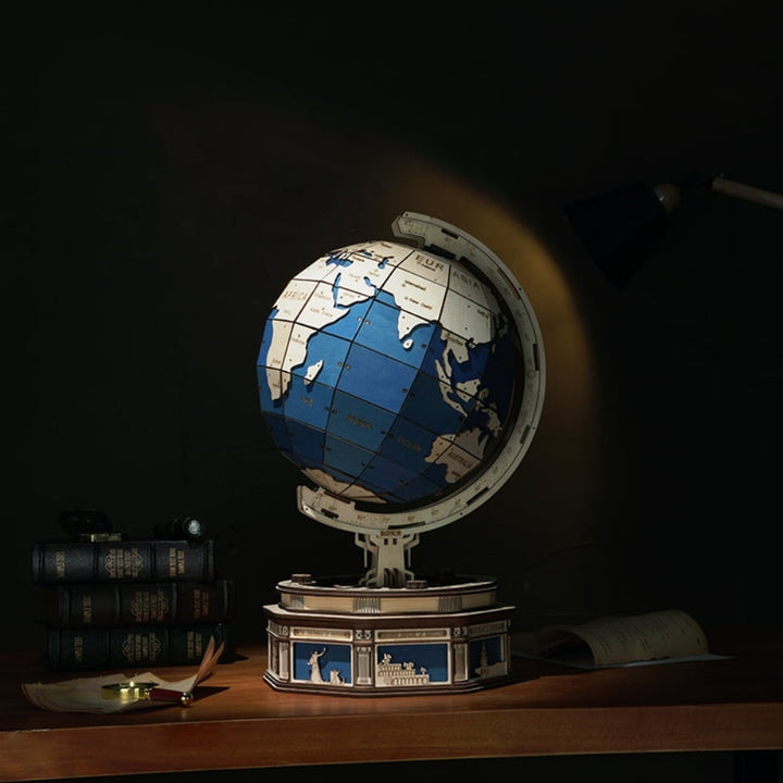 Globe on a wooden desk with books in the background