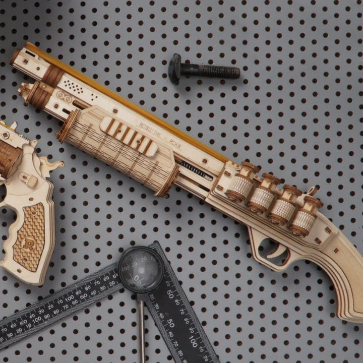 Wooden gun model with accessories on a pegboard background