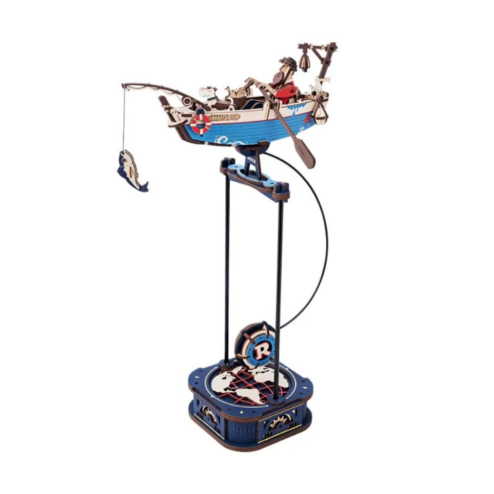Decorative spinning toy with a boat and figures on a white background