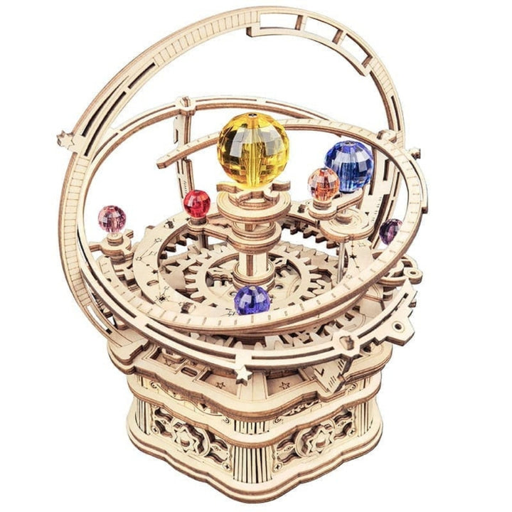Wooden mechanical model of a celestial sphere with colorful spheres on a white background