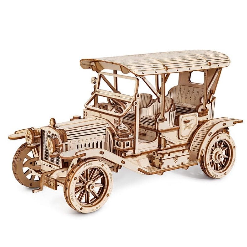 Wooden model of a vintage car on a white background