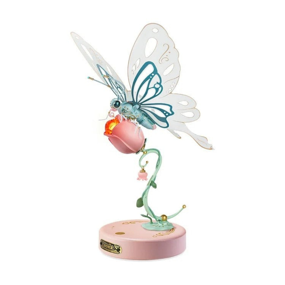 Decorative figurine of a butterfly on a pink flower with a white background