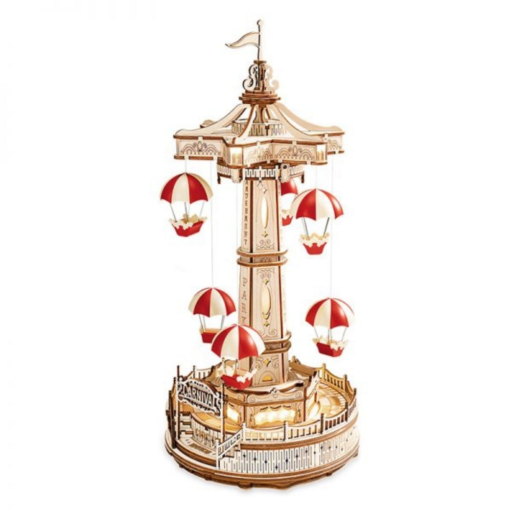Wooden model of a carousel with red and white striped canopy on a white background