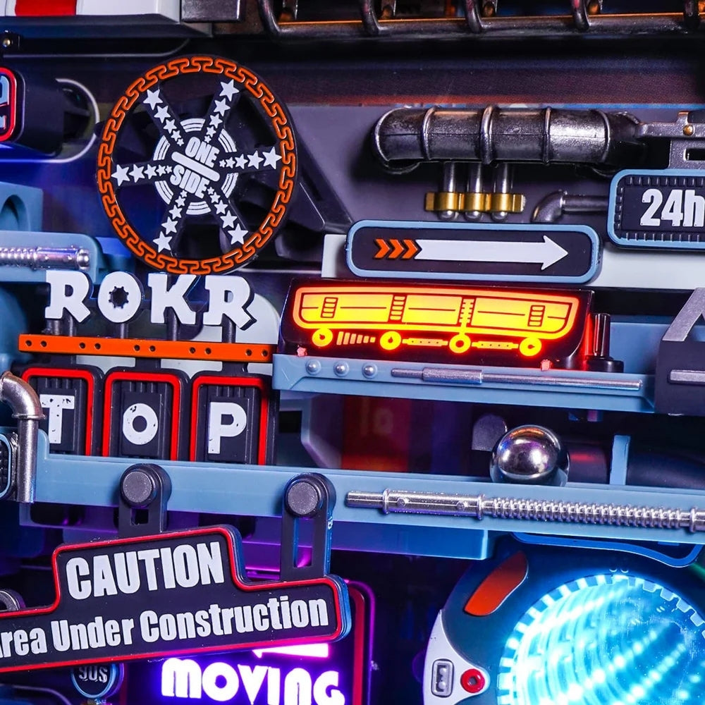 Close-up of a toy vehicle with various signs and lights, including 'ROKR', 'STOP', and 'Caution'.