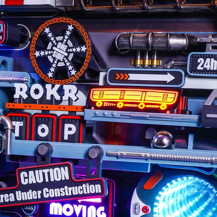 Close-up of a toy vehicle with various signs and lights, including 'ROKR', 'STOP', and 'Caution'.