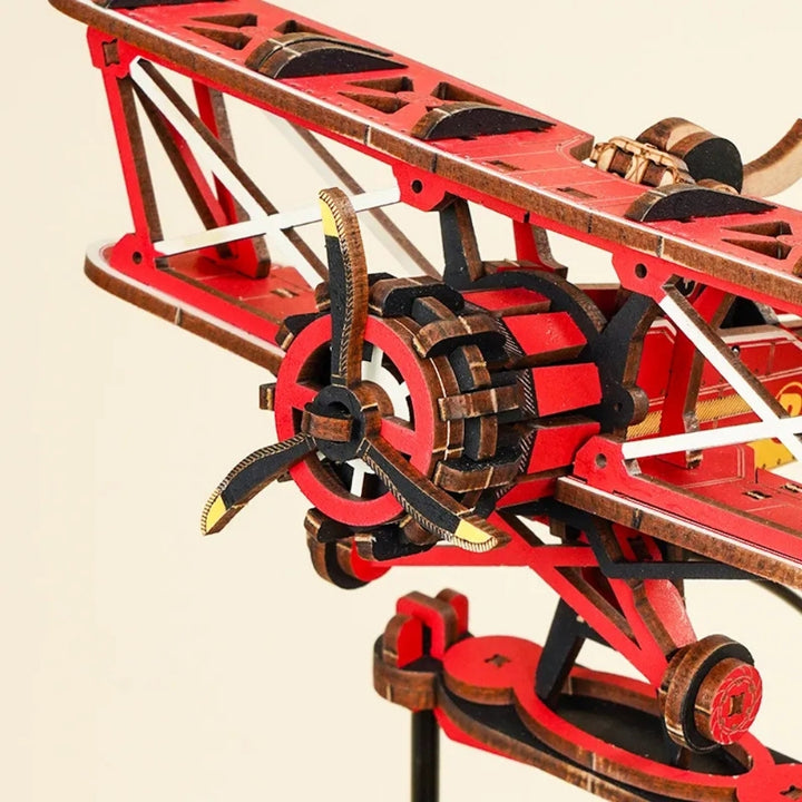 Close-up of a red and brown mechanical model on a beige background