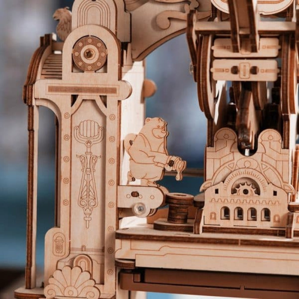 Wooden mechanical model with intricate details and a bear figure.