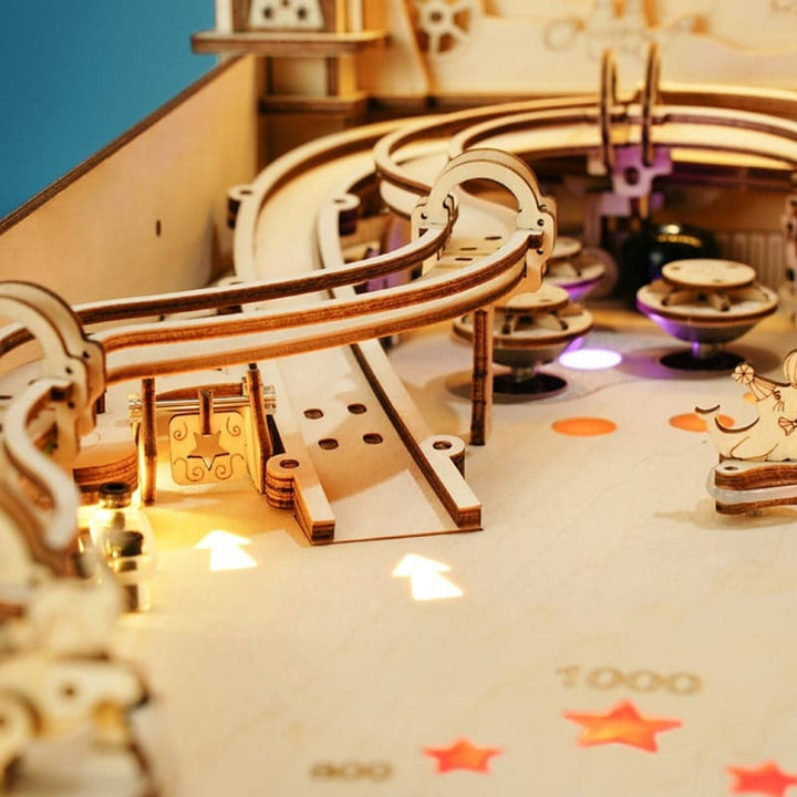 Wooden toy roller coaster with tracks and cars on a colorful surface