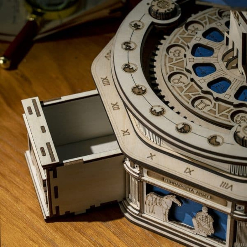 Wooden mechanical model with gears and a film strip on a wooden surface