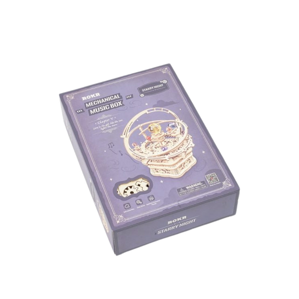 Mechanical music box packaging with starry night design on a white background