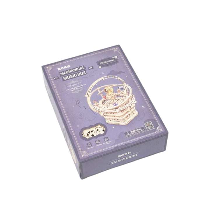 Mechanical music box packaging with starry night design on a white background